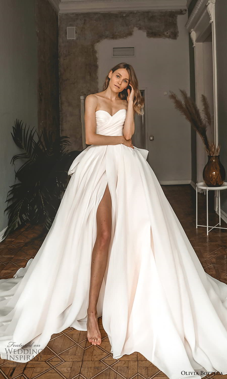 https://www.weddinginspirasi.com/wp-content/uploads/2021/09/olivia-bottega-2022-capsule-bridal-strapless-sweetheart-neckline-ruched-bodice-a-line-ball-gown-wedding-dress-chapel-train-slit-skirt-1-mv.jpg