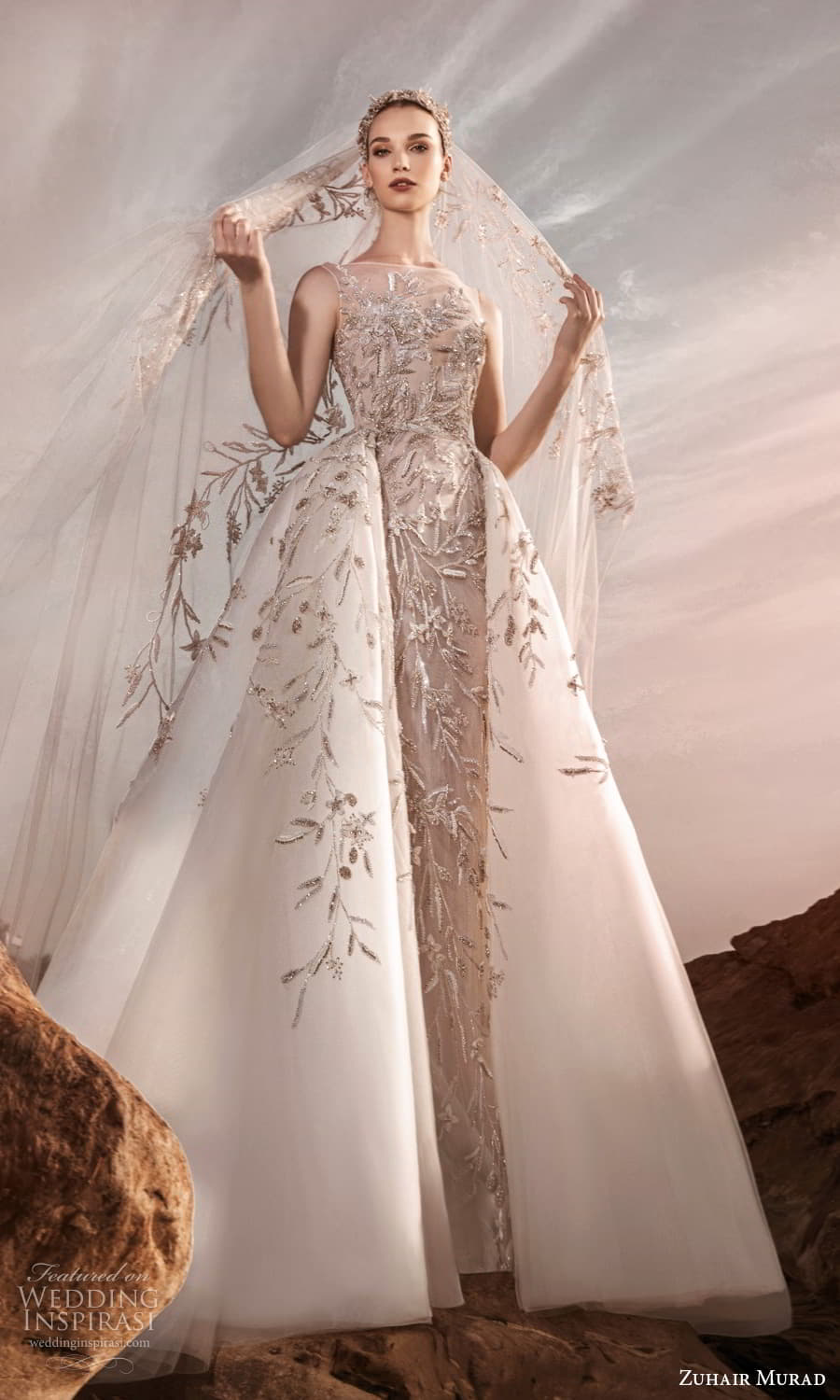 zuhair murad spring 2025 bridal sleeveless sheer bateau neckline heavily embellished sheath wedding dress a line ball gown overskirt chapel train (10) mv